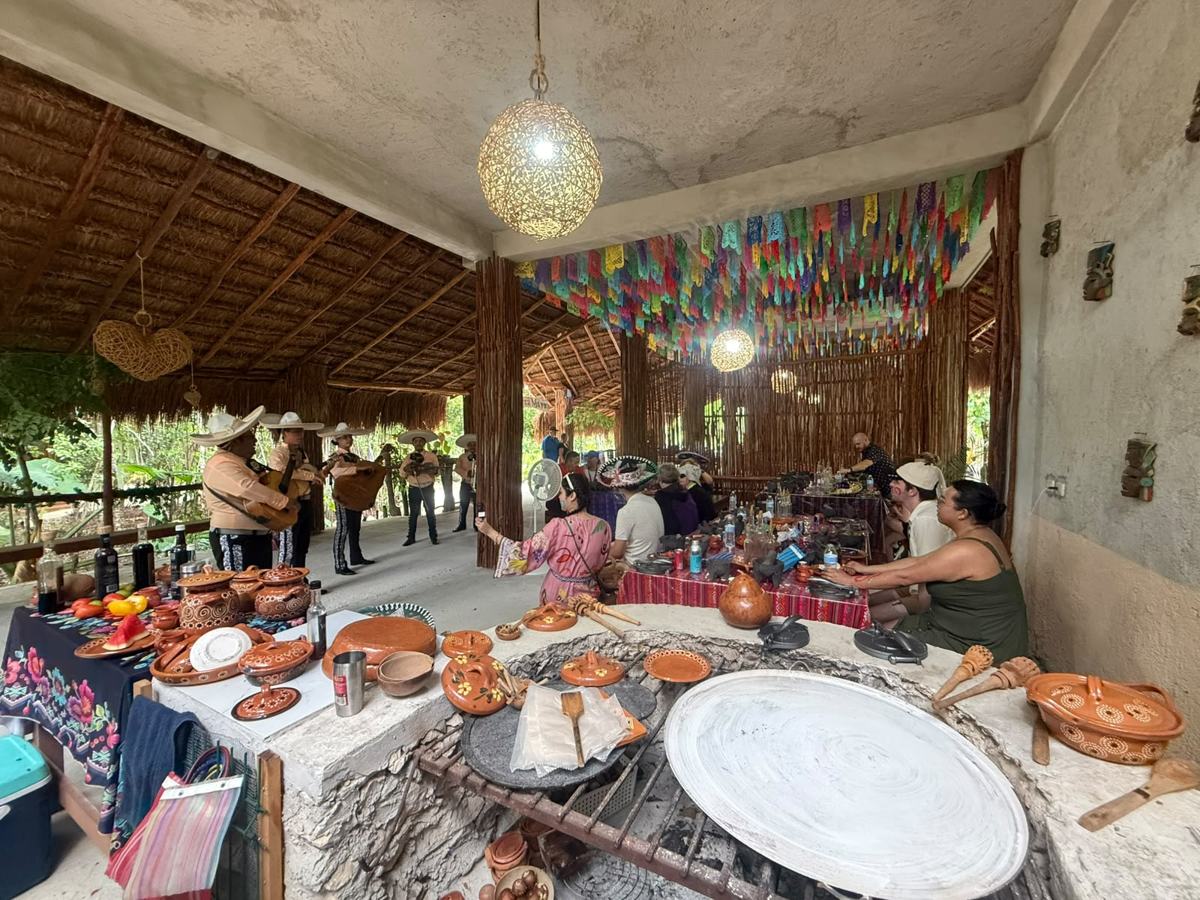 The open-fire stone hearth, with mariachis and families behind