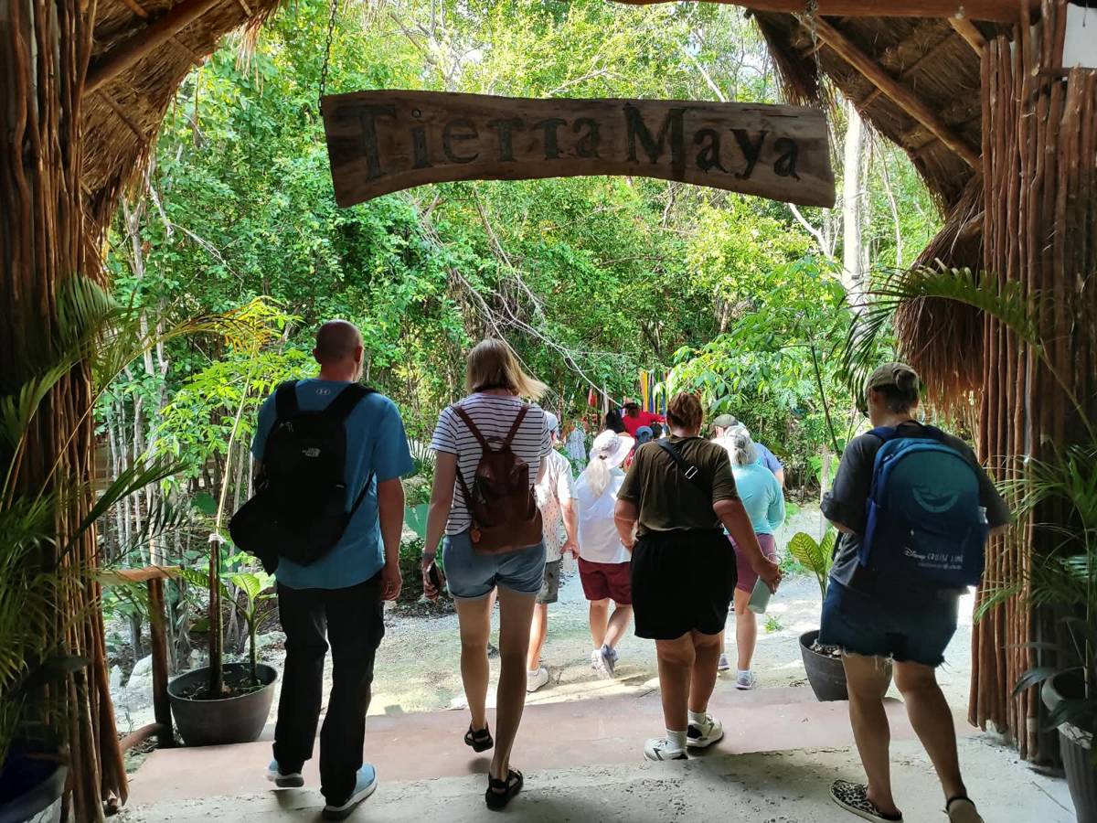 Guests walking in under the carved Tierra Maya sign