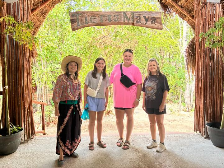 Four guests at the entrance arch