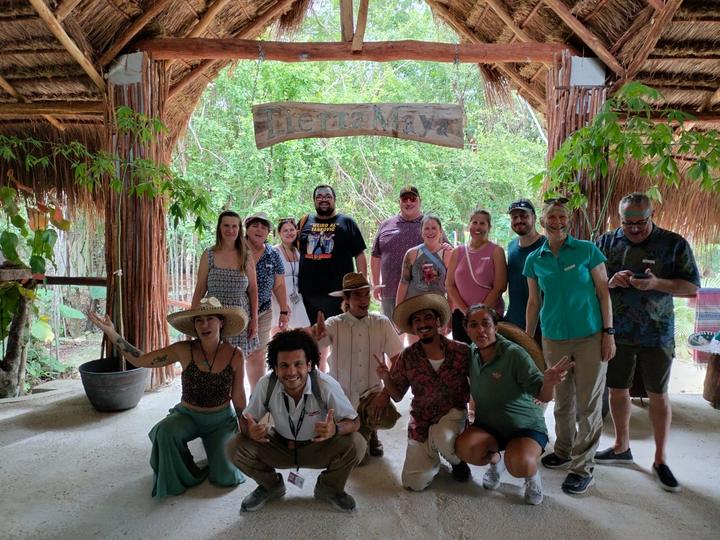 A group of about 18 with guides kneeling in front