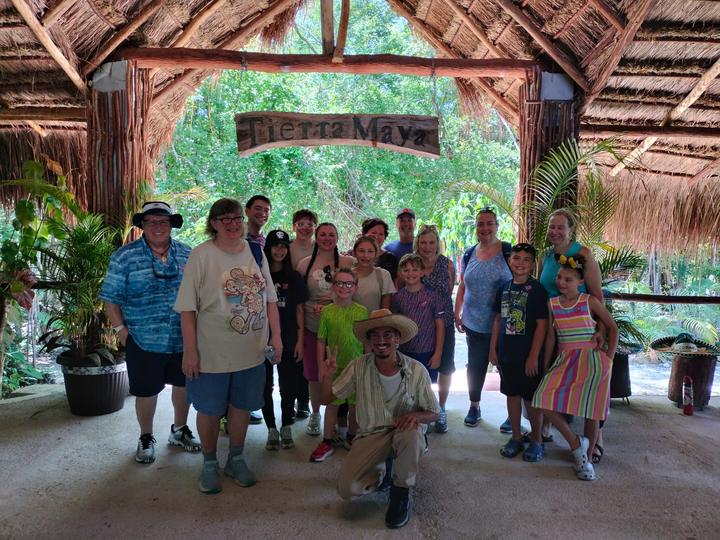 Group of fifteen with kids, guide kneeling